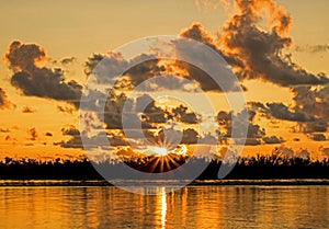 Sun Bursts Above The Horizon Across The Caribbean Tidal Pool