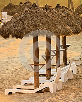 Sun Chairs and Huts on the beach of a resort in Mexico