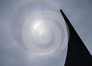 Sun with circular rainbow.