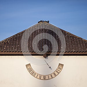 Sun clock on house