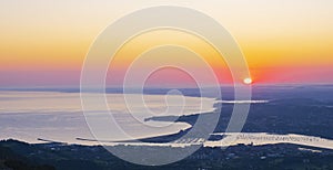 The sun at dawn over the cities of Irun and Hondarribia photo