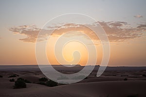 Sun at dawn in the sahara desert in morocco