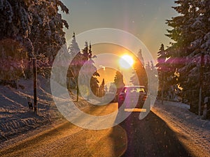 Sun dazzles motorists in the Winter landscape photo