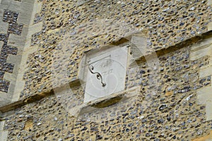 sun dial on the walls of medieval parish church in England
