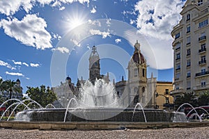 The sun is directly above the fountain in PlaÃÂ§a de l`Ajuntament, Valencia, Spain photo