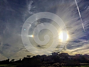 Sun Dog Phenomenon near sunset in clouds and jet stream over St. George Neighborhood