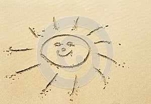 Sun drawing on sandy beach