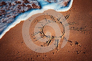 Sun drawn on the sand of a beach