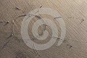 Sun drawn on sand
