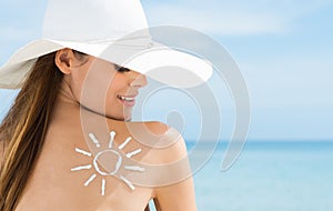 Sun Drawn On Woman's Shoulder With Sun Protection Cream