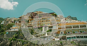 The sun-drenched Positano hillside displays its vibrant architecture against the Tyrrhenian Sea. The colorful cliffside