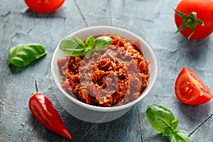 Sun dried tomato pesto in white bowl.