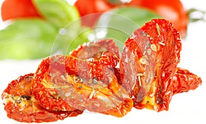 Sun-dried tomatoes with basil leaves