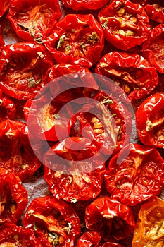 Sun dried tomatoes, dried red cherry tomatoes, close up, top view.