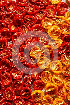 Sun dried tomatoes, dried red and yellow cherry tomatoes, close up,