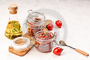 Sun dried tomatoes with fresh herbs and spices. Delicious snack on a light background, top view. Long banner format. space for