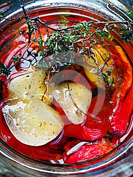 Sun dried tomatoes with garlic with glass jar top view