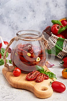 Sun dried tomatoes with herbs, garlic and olive oil in jar