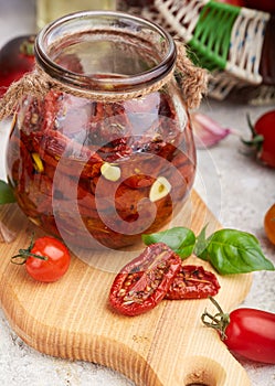 Sun dried tomatoes with herbs, garlic and olive oil in jar