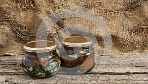 Sun dried tomatoes with herbs and olive oil in jar