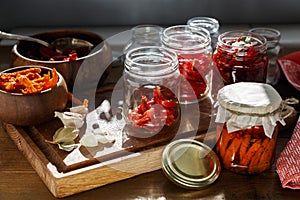 Sun dried tomatoes with herbs and sea salt in olive oil in a glass jar