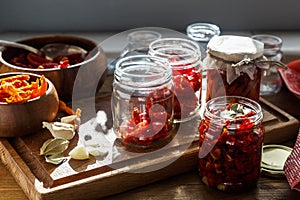 Sun dried tomatoes with herbs and sea salt in olive oil in a glass jar