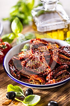 Sun-dried tomatoes marinated in olive oil with herbs and olives