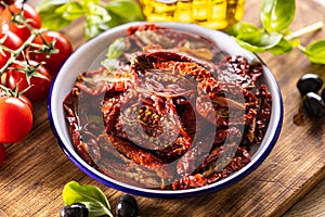 Sun-dried tomatoes marinated in olive oil with herbs and olives