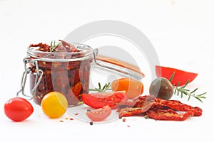 Sun dried tomatoes in olive oil with fresh herbs, spices and sea salt in a glass jar