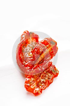 Sun-dried tomatoes with olive oil in an old white wood