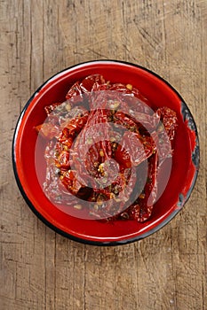 Sun-dried tomatoes with olive oil in red enamel