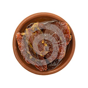 Sun dried tomatoes with olive oil in small dish