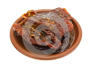 Sun dried tomatoes with olive oil in small dish