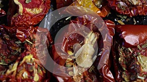 Sun-dried tomatoes with spices and garlic on a baking sheet. Close up