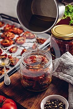Sun Dried Tomatoes and Thyme with Olive Oil in a Glass Jar