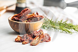 Sun dried tomatoes on white table