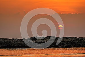 The sun of fiery orange colorful sunset / sunrise with clouds sky in the sea, Beautiful sky