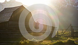 Sun flairs falling on historical antique barn