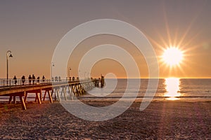 People walking on the jetty to see sunset, Glenelg beach, South Australia