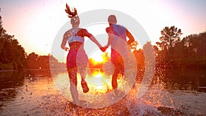 SUN FLARE: Sporty couple jogging in the serene nature at stunning golden sunrise