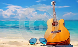 Sun glasses and acoustic guitar on the beach with turquoise sea background.