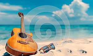 Sun glasses and acoustic guitar on the beach with turquoise sea background.