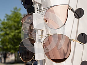 Sun glasses on the counter. two pairs of sunglasses in different colors