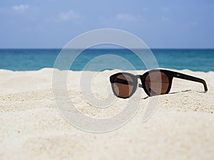 Sun glasses on Sand Beach Summer Holiday Travelling background