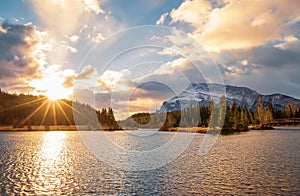 Sun Glow Over A Banff Mountain Park