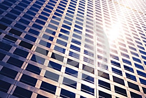 Sun glow between the windows of the skyscraper