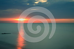 Sun glowing on a smooth lake