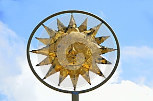 Sun God symbol against blue skies