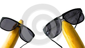 Sun goggles dressed on a banana head, funny fruits in glasses,isolated on white,close-up.