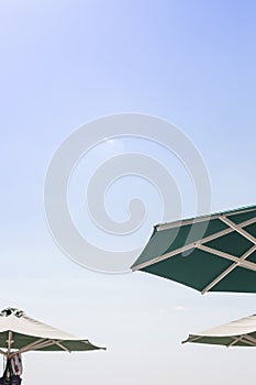 Sun green open umbrella, comfortable rest by the ocean with personal beach parasol on beautiful cote dazur coastline
